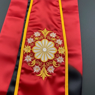 Close-up of a satin graduation stole with intricate embroidery